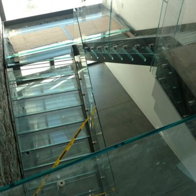 Glass Unlimited Glass railing with glass treads and glass flooring. This is an all Glass staircase.