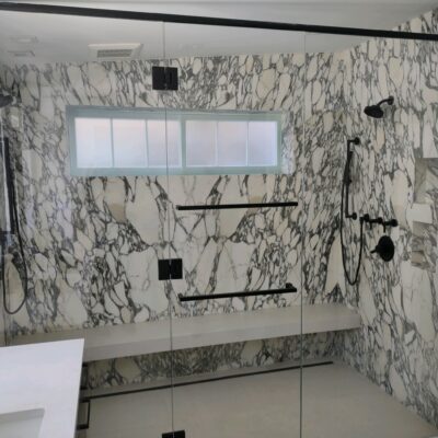 Dual Shower and Glass Enclosure Frameless shower door.