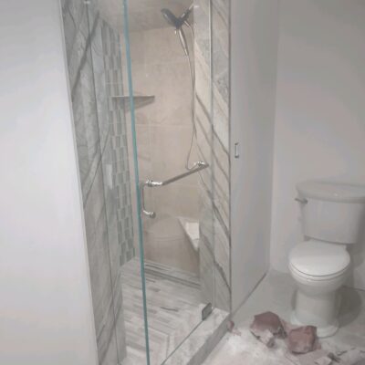 Custom Glass Shower enclosure with frameless glass and custom hardware.