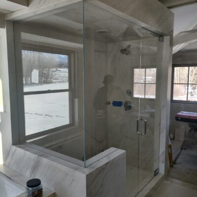Custom Glass Bathroom Enclosure in Snowmass Village Colorado. Polished Steele hardware.