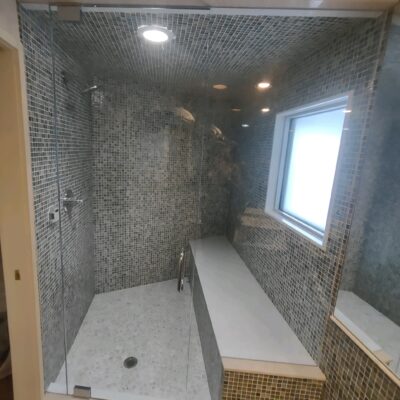 Custom Glass Bathroom Enclosure polished Steele hardware.